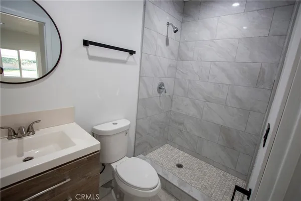 a bathroom with a sink a toilet and a mirror