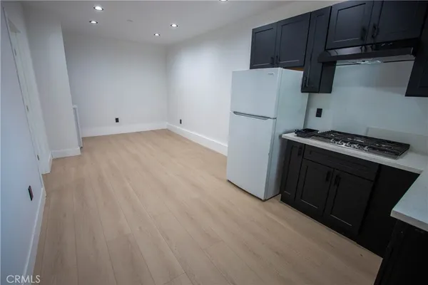 a kitchen with stainless steel appliances a refrigerator and a stove top oven