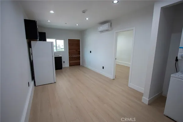 a view of an empty room with a kitchen