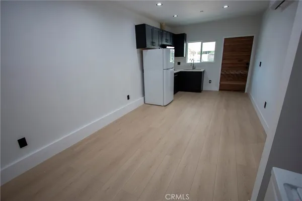 a view of a kitchen with refrigerator and a sink