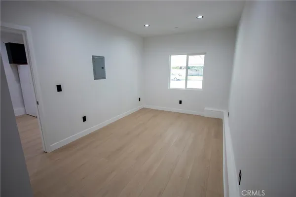 a view of empty room with wooden floor