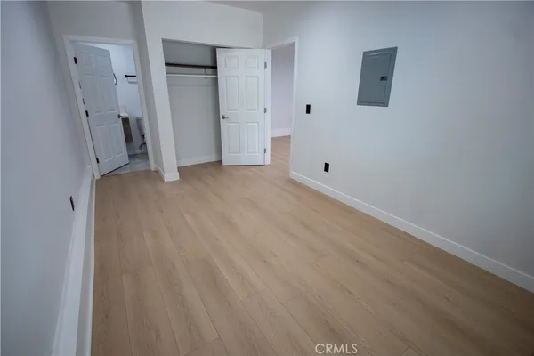 a view of a room with wooden floor