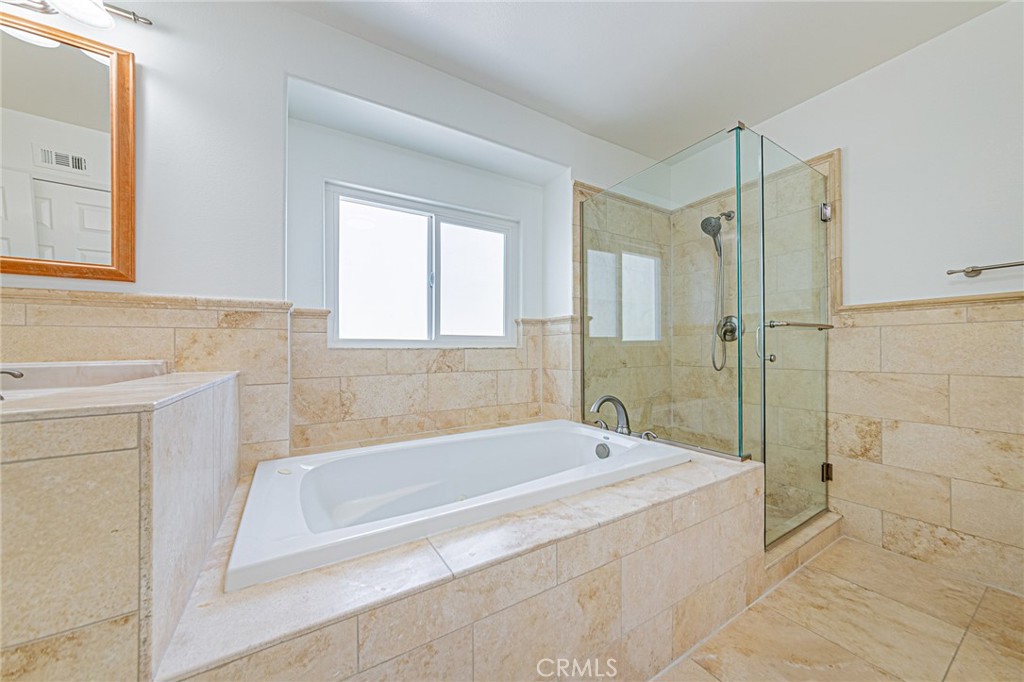 25533 Longfellow Place Stevenson Ranch, CA 91381 - Photo 24 of 47 a spacious bathroom with a bathtub and shower