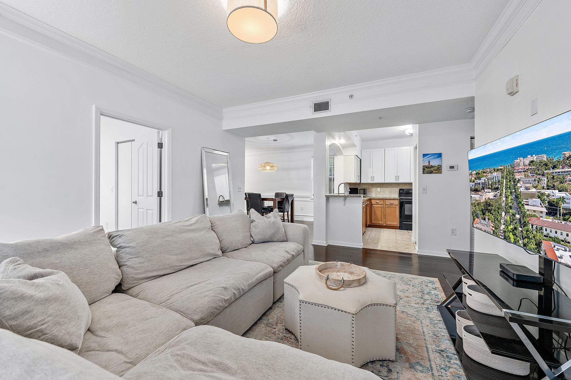 225 Murcia Drive, Unit 201 Jupiter, FL 33458 - Photo 14 of 42 a living room with furniture and a flat screen tv