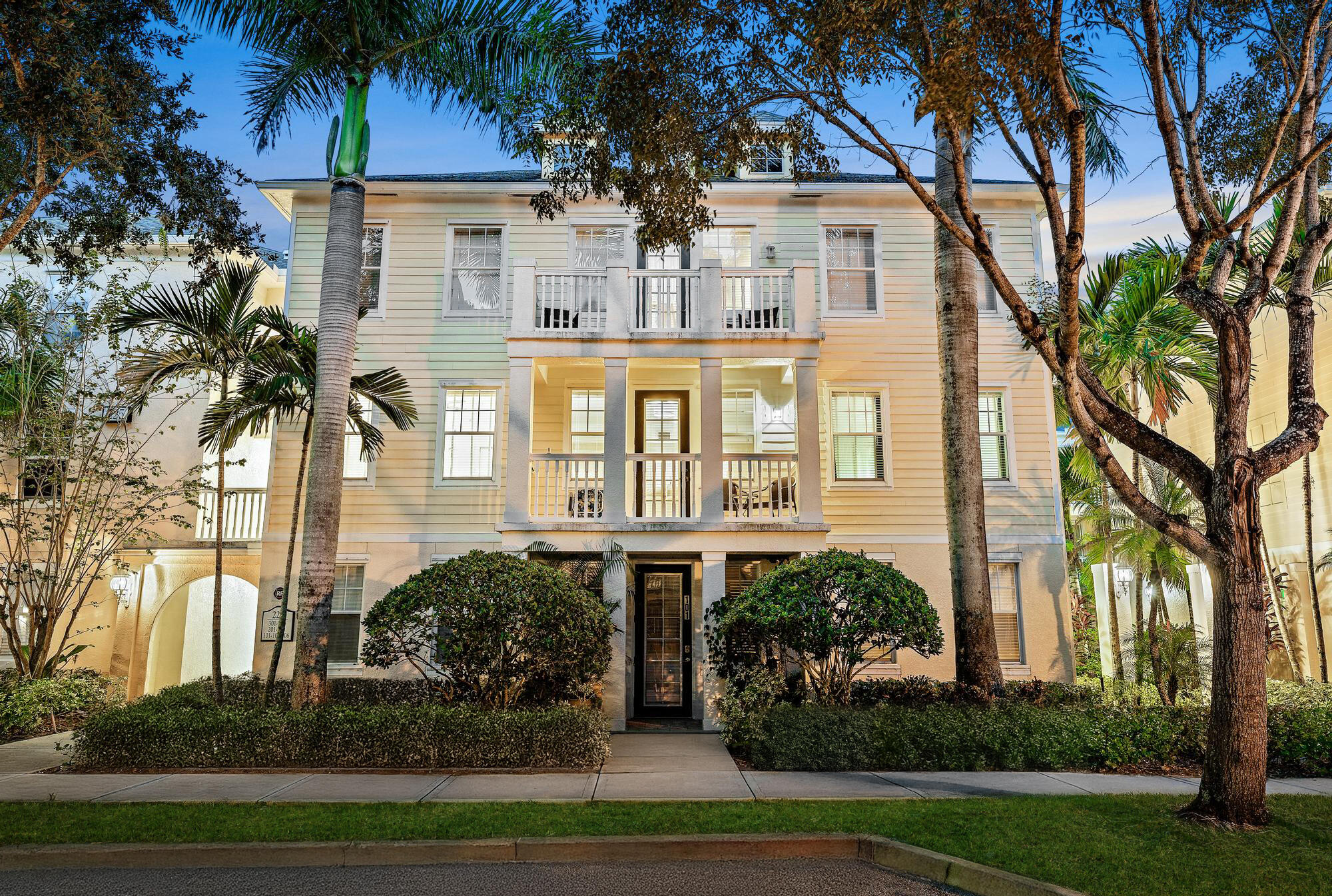 225 Murcia Drive, Unit 201 Jupiter, FL 33458 - Photo 2 of 42 a front view of a house with a garden