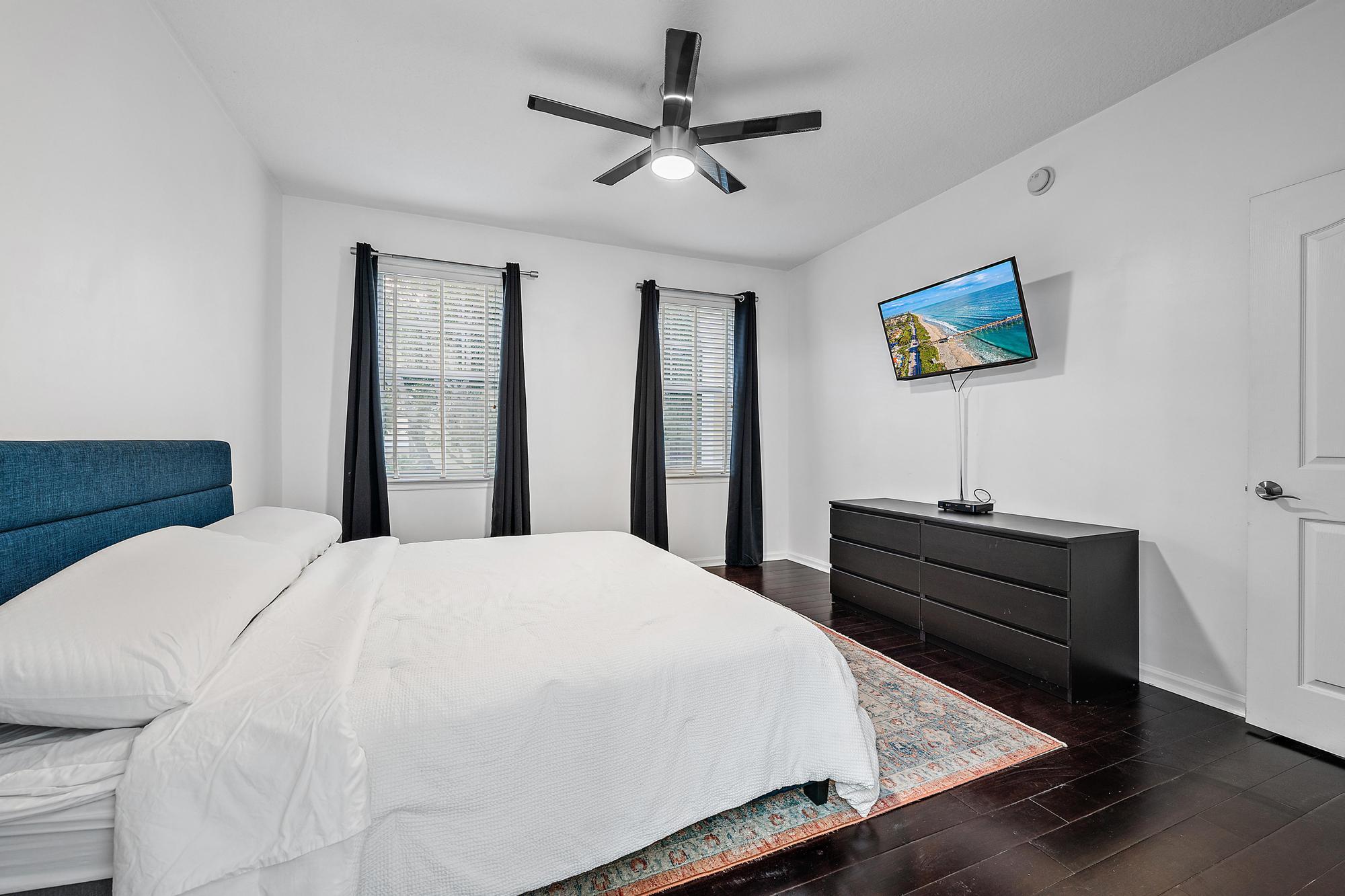 225 Murcia Drive, Unit 201 Jupiter, FL 33458 - Photo 22 of 42 a bedroom with a bed and wooden floor