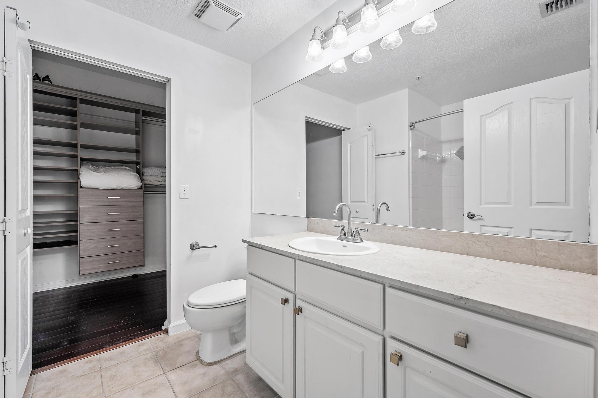 225 Murcia Drive, Unit 201 Jupiter, FL 33458 - Photo 24 of 42 a bathroom with a sink a toilet and shower
