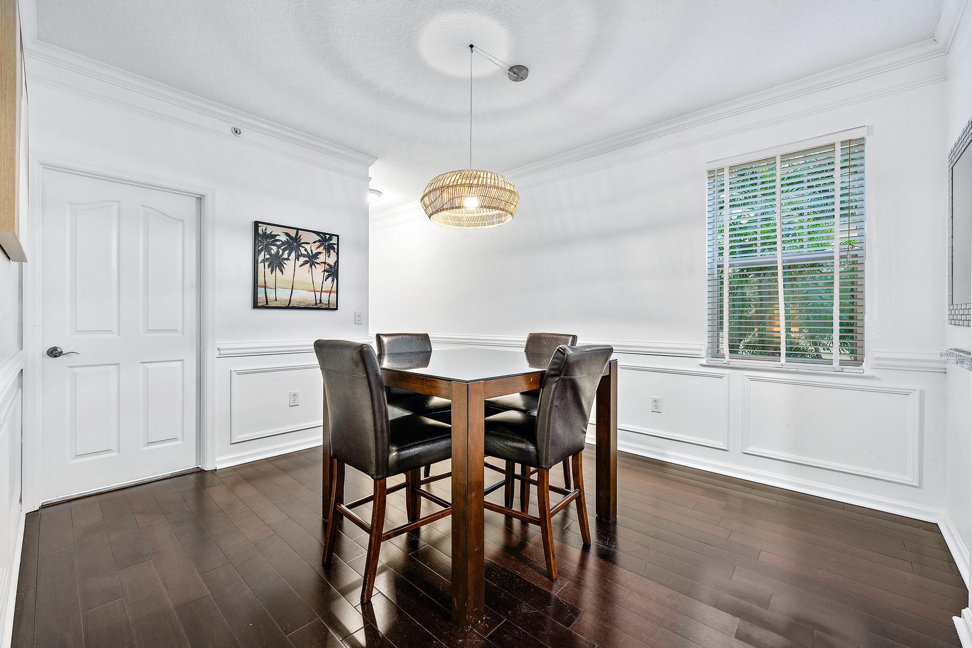 225 Murcia Drive, Unit 201 Jupiter, FL 33458 - Photo 4 of 42 a view of a dining room with furniture and chandelier