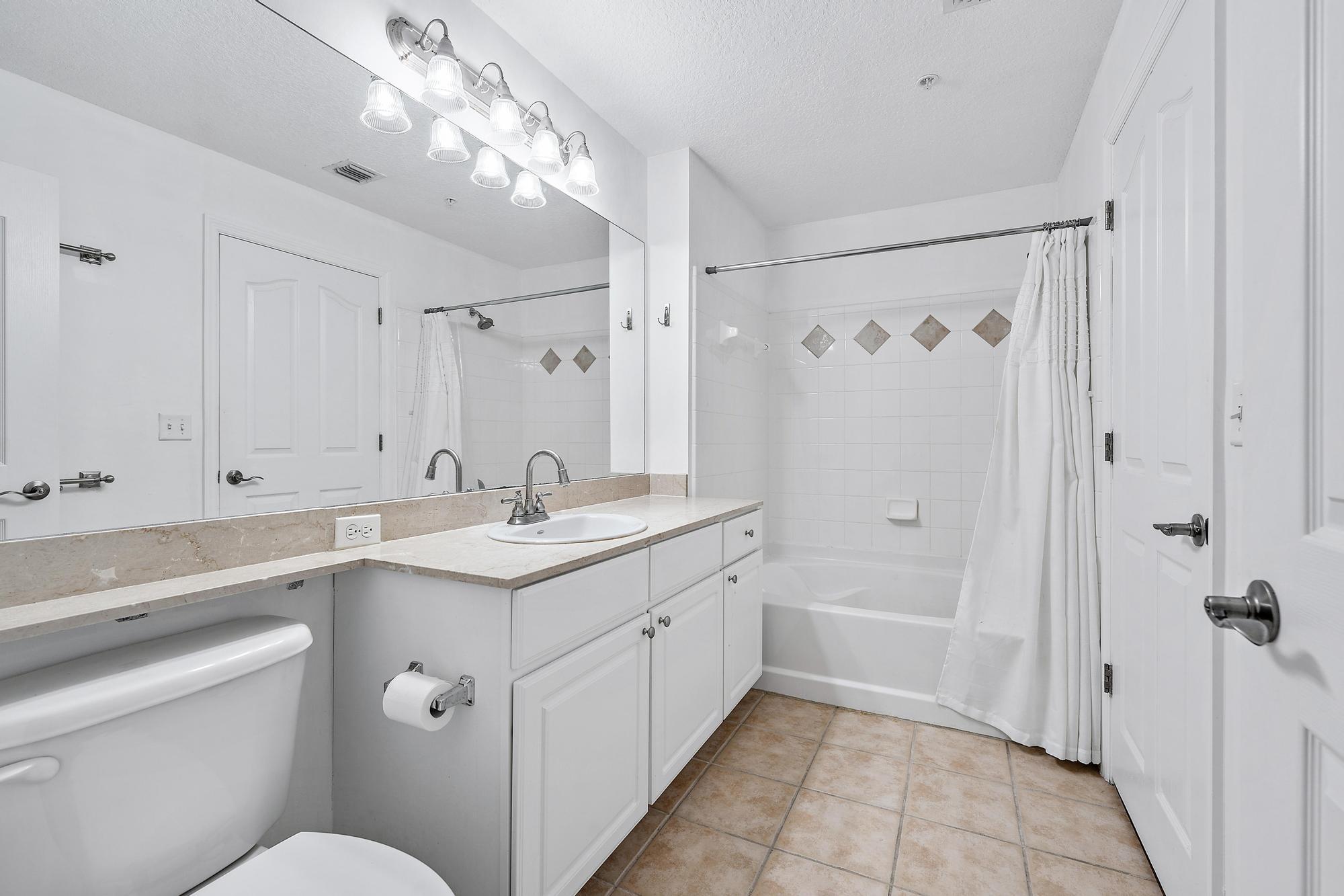 225 Murcia Drive, Unit 201 Jupiter, FL 33458 - Photo 7 of 42 a bathroom with a sink a toilet and shower