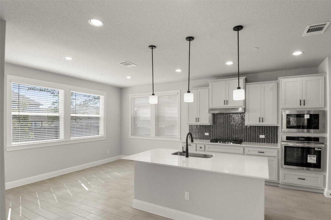 2605 Sam Bass Road, Unit 87 Round Rock, TX 78681 - Photo 15 of 31 a view of kitchen with stainless steel appliances sink stove and cabinets