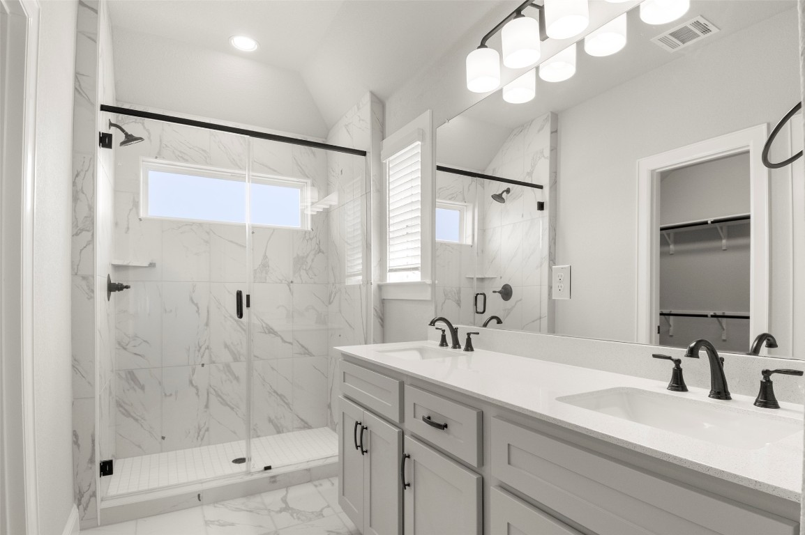 2605 Sam Bass Road, Unit 87 Round Rock, TX 78681 - Photo 19 of 31 a bathroom with a double vanity sink mirror and shower