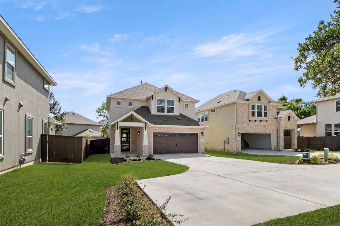 2605 Sam Bass Road, Unit 87 Round Rock, TX 78681 - Photo 2 of 31 a front view of a house with a yard and garage