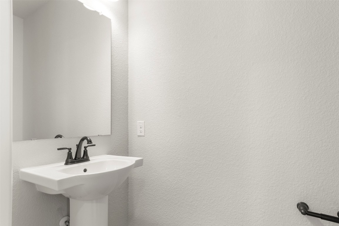 2605 Sam Bass Road, Unit 87 Round Rock, TX 78681 - Photo 28 of 31 a bathroom with a sink and mirror