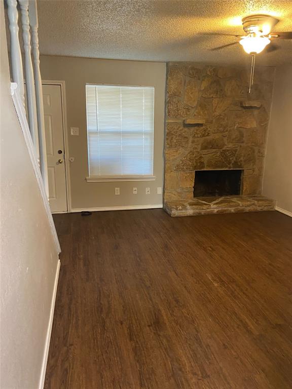 1607 North Nolan River Road, Unit D Cleburne, TX 76033 - Photo 1 of 7 a view of a livingroom with wooden floor and a fireplace