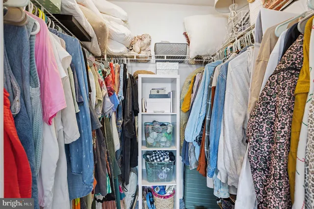 a bathroom with a toilet sink vanity tub and mirror