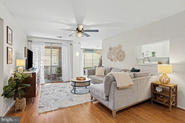 a living room with furniture chandelier and a flat screen tv