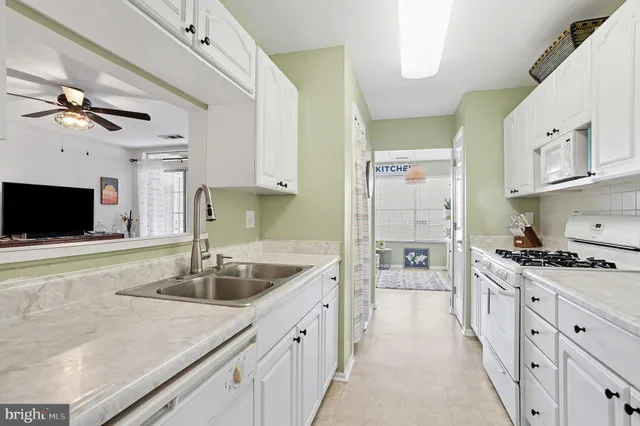 a kitchen with stainless steel appliances granite countertop a sink and a stove