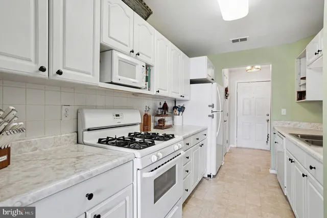 a kitchen with stainless steel appliances granite countertop a stove and a refrigerator