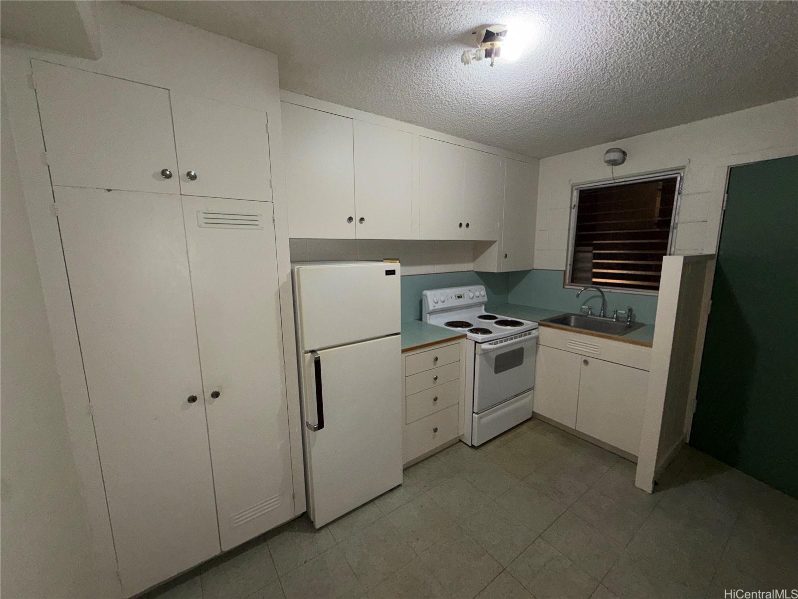 a kitchen with white cabinets and white appliances