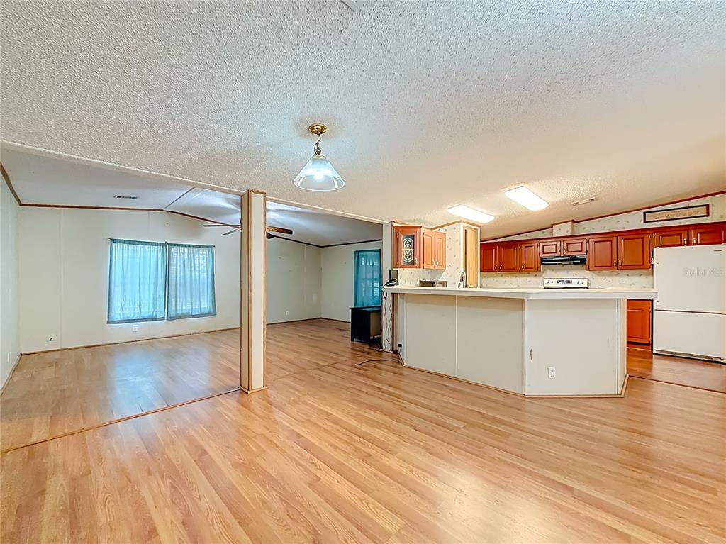 9575 Southwest 155th Street Dunnellon, FL 34432 - Photo 11 of 50 a view of a kitchen with wooden floor and electronic appliances