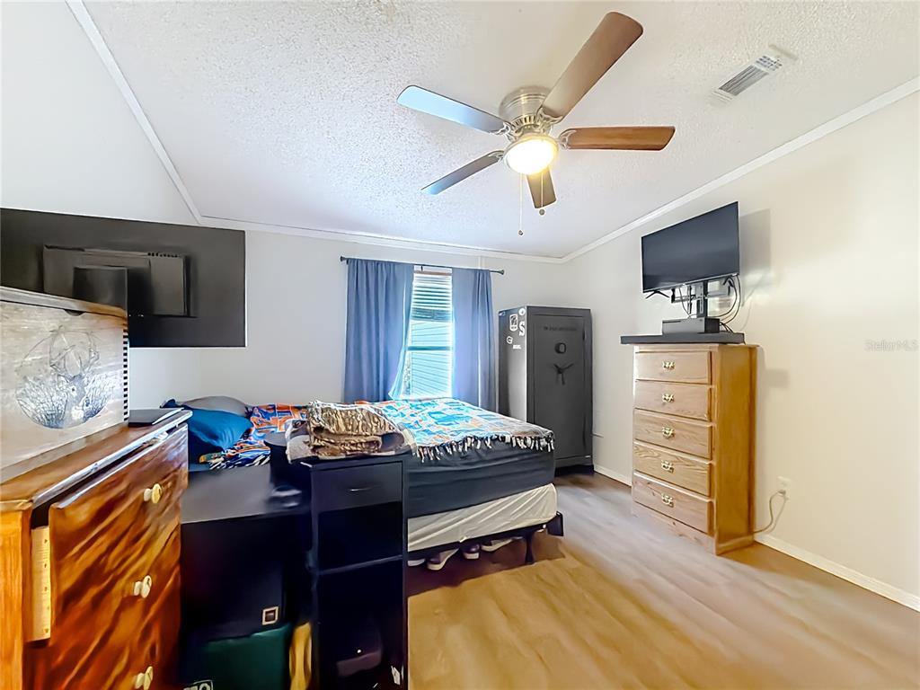 9575 Southwest 155th Street Dunnellon, FL 34432 - Photo 29 of 50 a living room with furniture and a flat screen tv