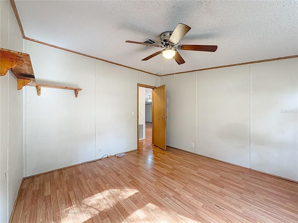 9575 Southwest 155th Street Dunnellon, FL 34432 - Photo 33 of 50 a view of empty room with wooden floor and fan