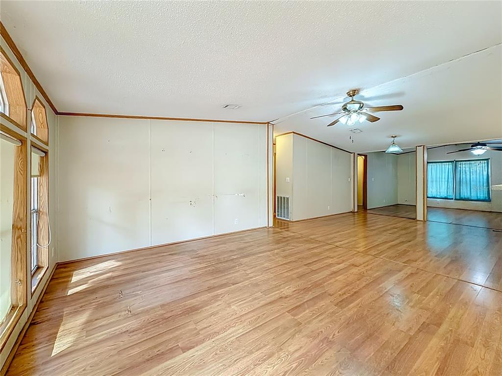 9575 Southwest 155th Street Dunnellon, FL 34432 - Photo 9 of 50 a view of an empty room with wooden floor and a window