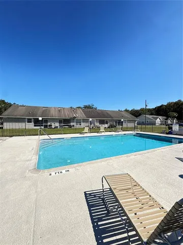 a view of a swimming pool with an outdoor seating and a garden