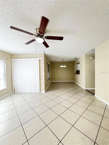 a view of a livingroom with a ceiling fan and window