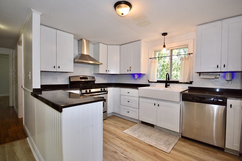 296 Lincoln Road Barnstable, MA 02601 - Photo 4 of 20 a kitchen with granite countertop cabinets stainless steel appliances a sink and a window