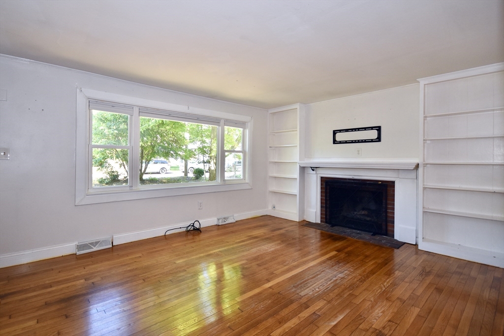 296 Lincoln Road Barnstable, MA 02601 - Photo 8 of 20 a view of empty room with wooden floor and fireplace