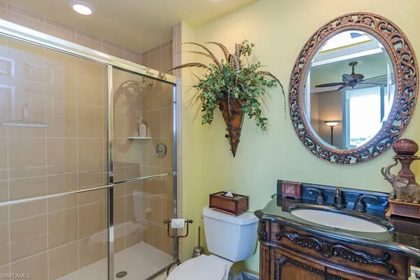 a bathroom with a toilet a sink and a mirror