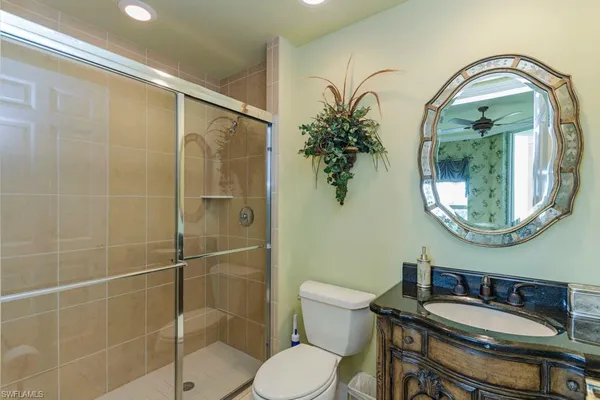 a bathroom with a sink toilet and a mirror