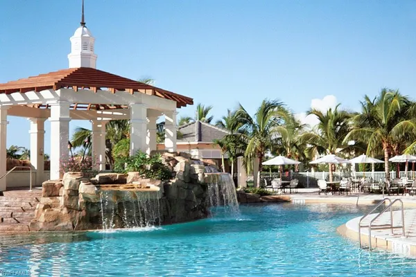 a view of a swimming pool with outdoor seating