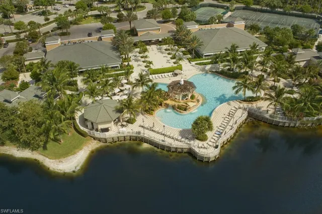 an aerial view of a house with a yard and lake view