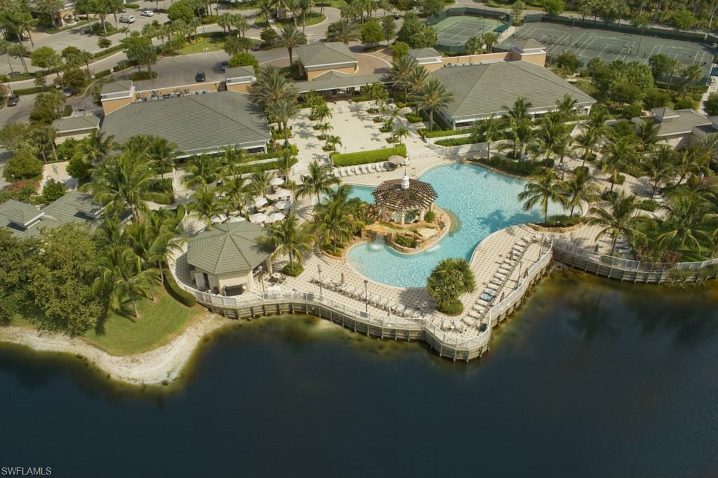 295 Grande Way, Unit 503 Naples, FL 34110 - Photo 19 of 24 an aerial view of a house with a yard and lake view