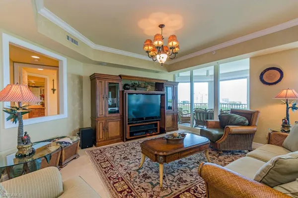 a living room with furniture a rug and a flat screen tv