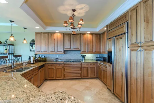 a kitchen with lots of counter top space and stainless steel appliances