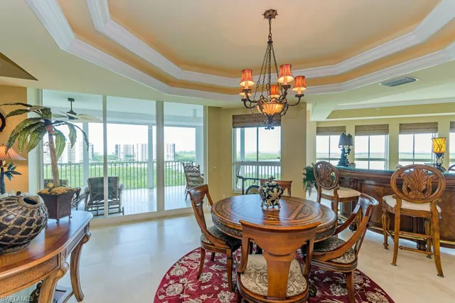 a view of a dining room with furniture wooden floor and chandelier