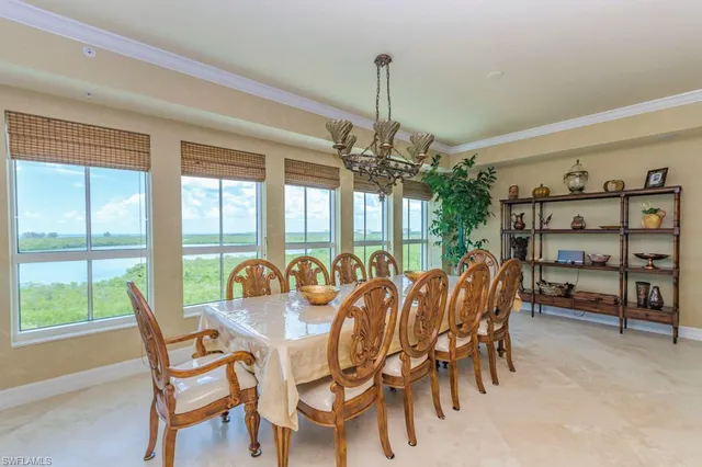 a view of a dining room with furniture window and outside view