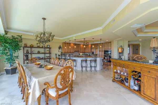 a dining room with furniture and a chandelier