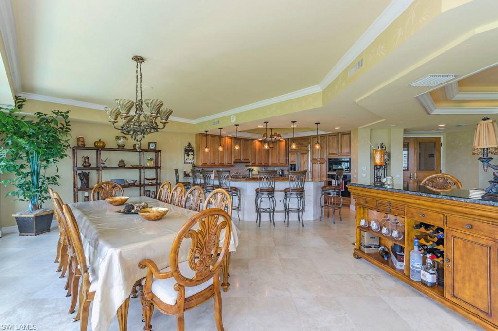 295 Grande Way, Unit 503 Naples, FL 34110 - Photo 6 of 24 a dining room with furniture and a chandelier
