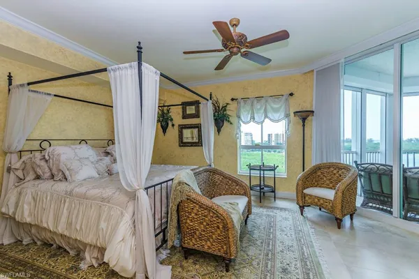 a living room with furniture ceiling fan and a window