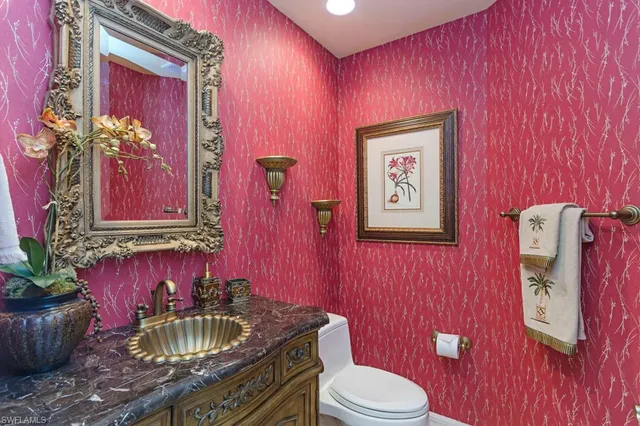 a bathroom with a toilet sink and mirror