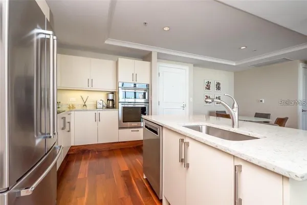 a kitchen with a sink stove and refrigerator
