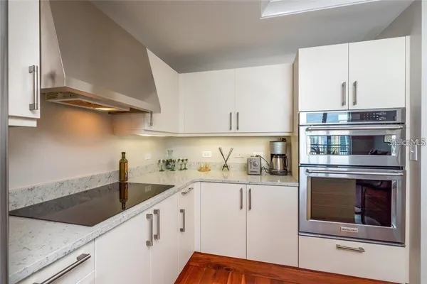 a kitchen with stainless steel appliances granite countertop a stove and a microwave