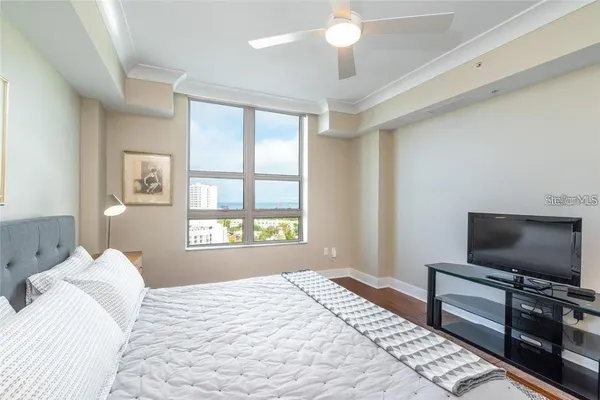 a bedroom with a large bed and a flat screen tv