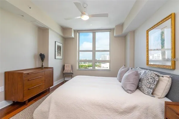 a bedroom with a bed and window with mirror