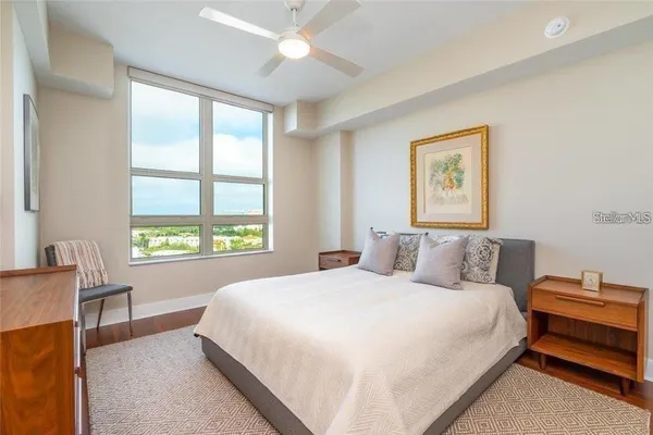 a bedroom with a bed and a window