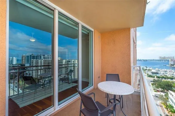 a balcony with table and chairs